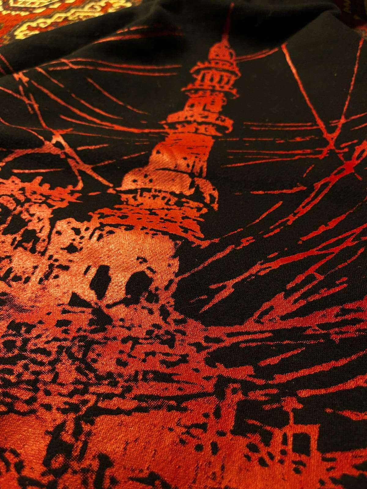 Textile with red and black design of a tower and abstract patterns
