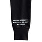 Black sweatshirt sleeve with white text on a white background